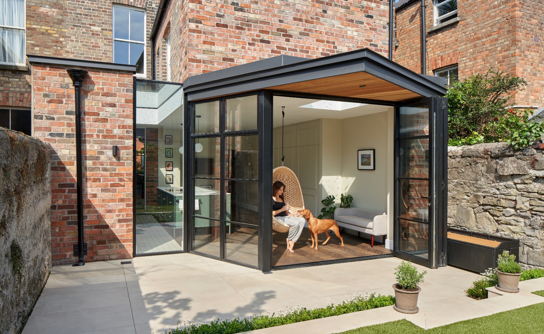 Modern glass-walled extension opening to a patio